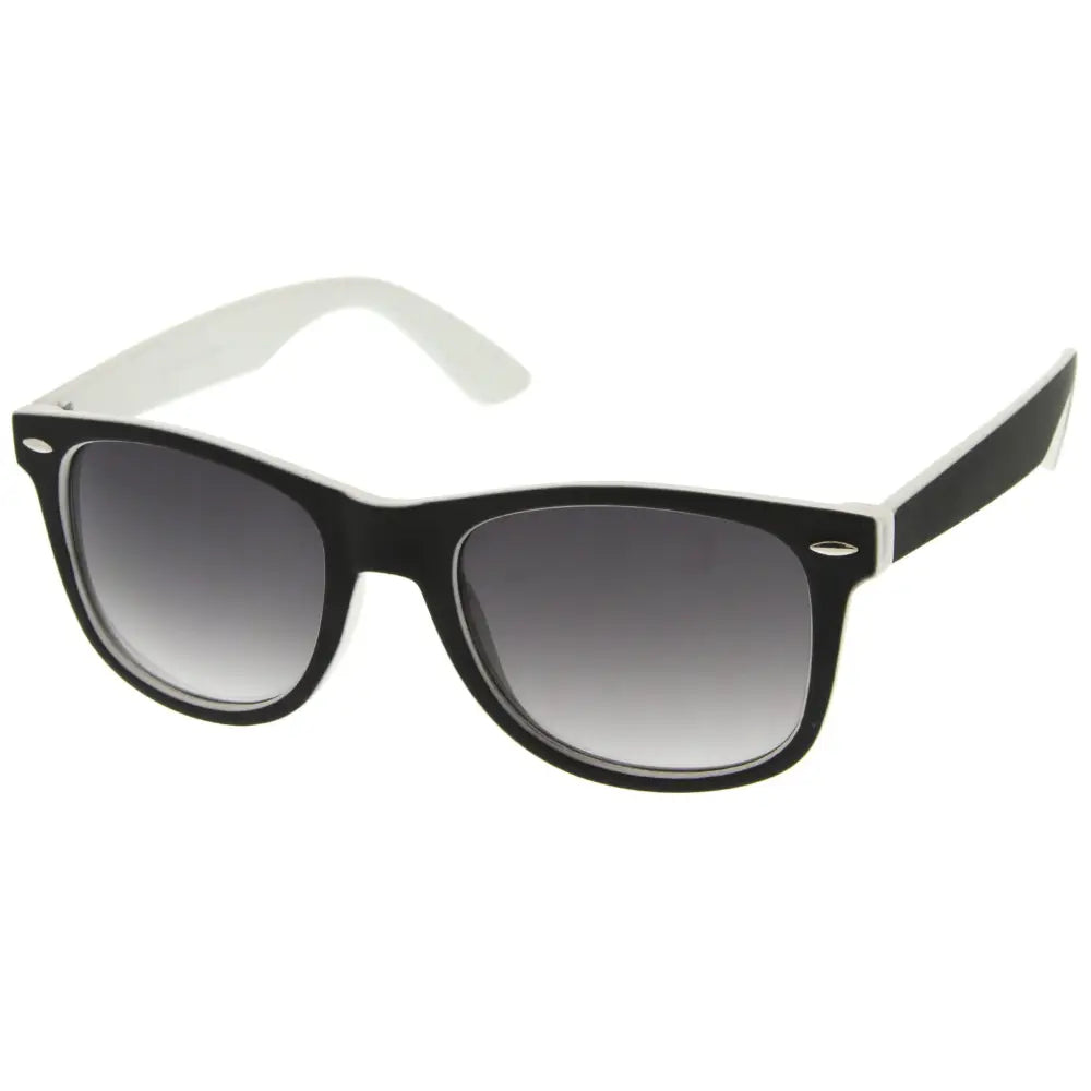 A set of 12 black and white two-tone plastic-framed sunglasses with gradient gray lenses and rectangular shape