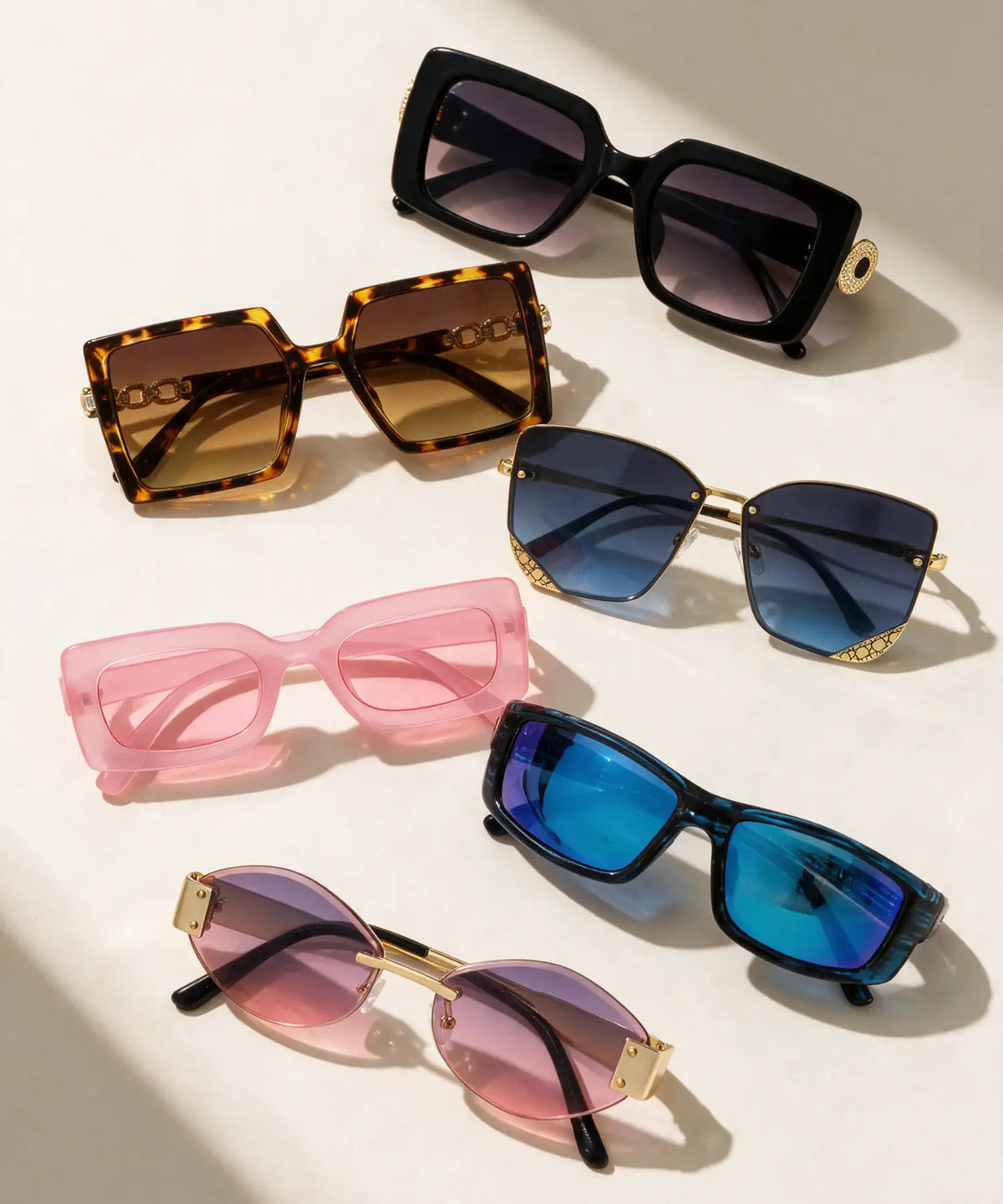 Black square-framed sunglasses with gold-tone decorative accents on the temples.