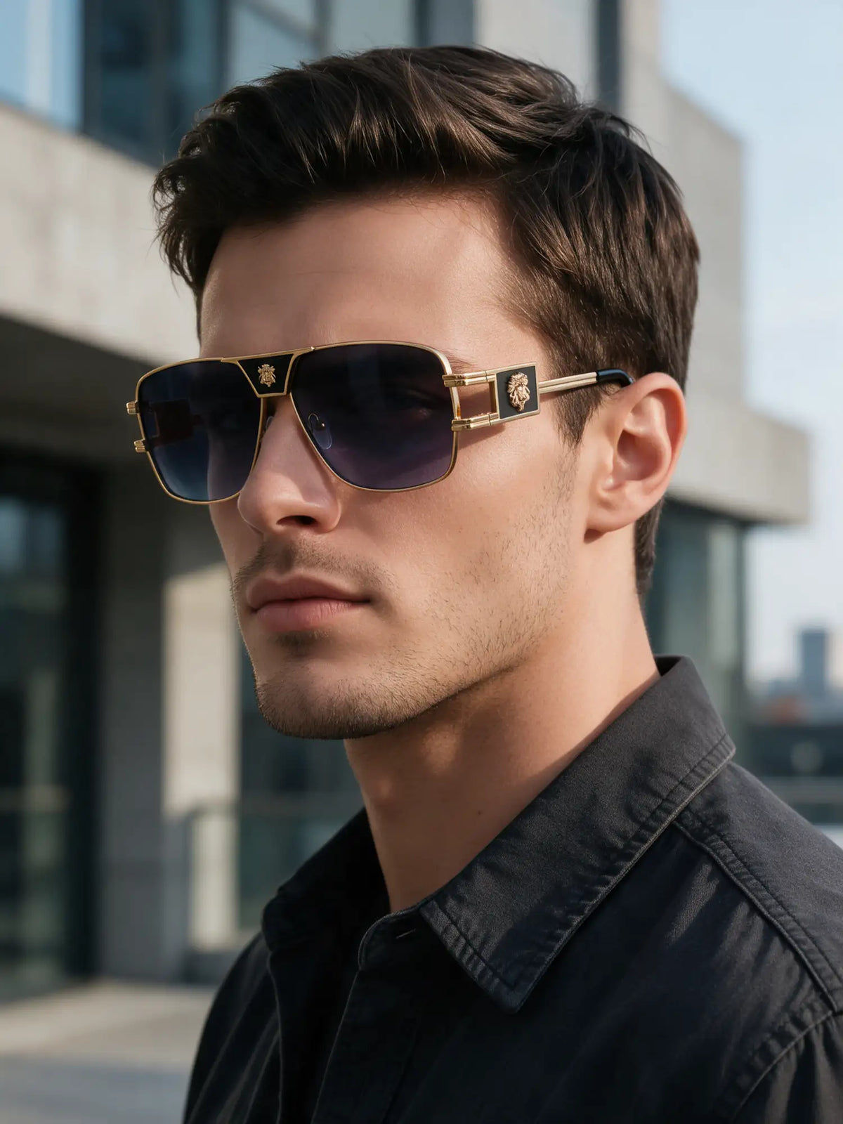 Gold-rimmed aviator sunglasses with dark gradient lenses and a lion emblem on the temple.
