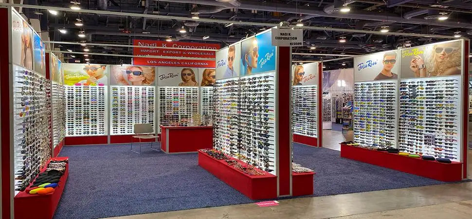 Rows of sunglasses on display at a trade show booth.