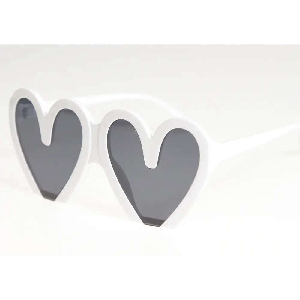 White heart-shaped sunglasses with dark gray lenses shown in a set of 12 labeled sa943